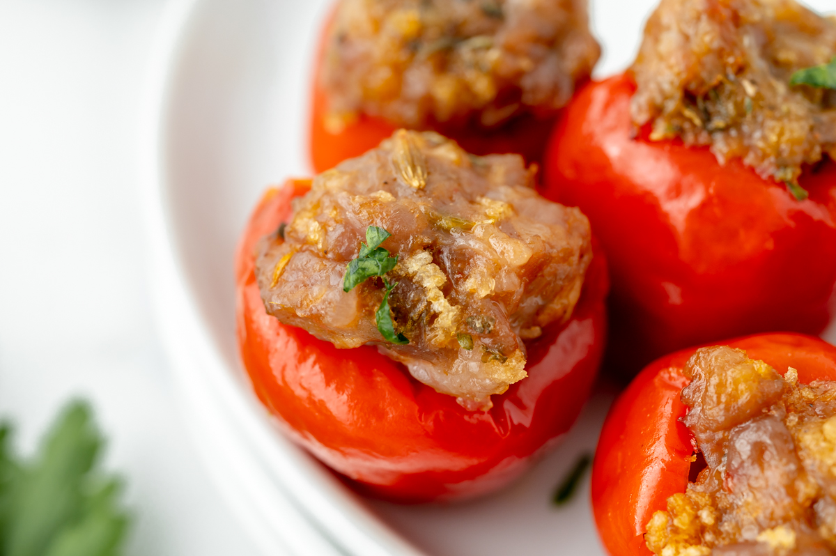 close up angled shot of stuffed cherry peppers on plate