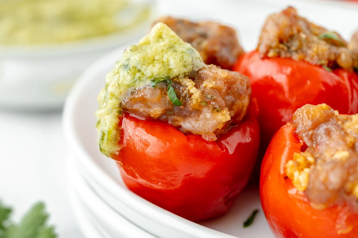 close up straight on shot of stuffed cherry pepper topped with sauce