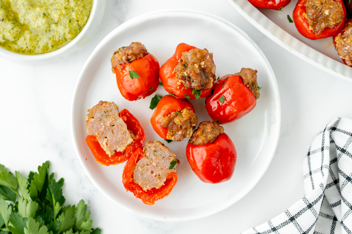 overhead shot of peppadew peppers on plate with one cut in half