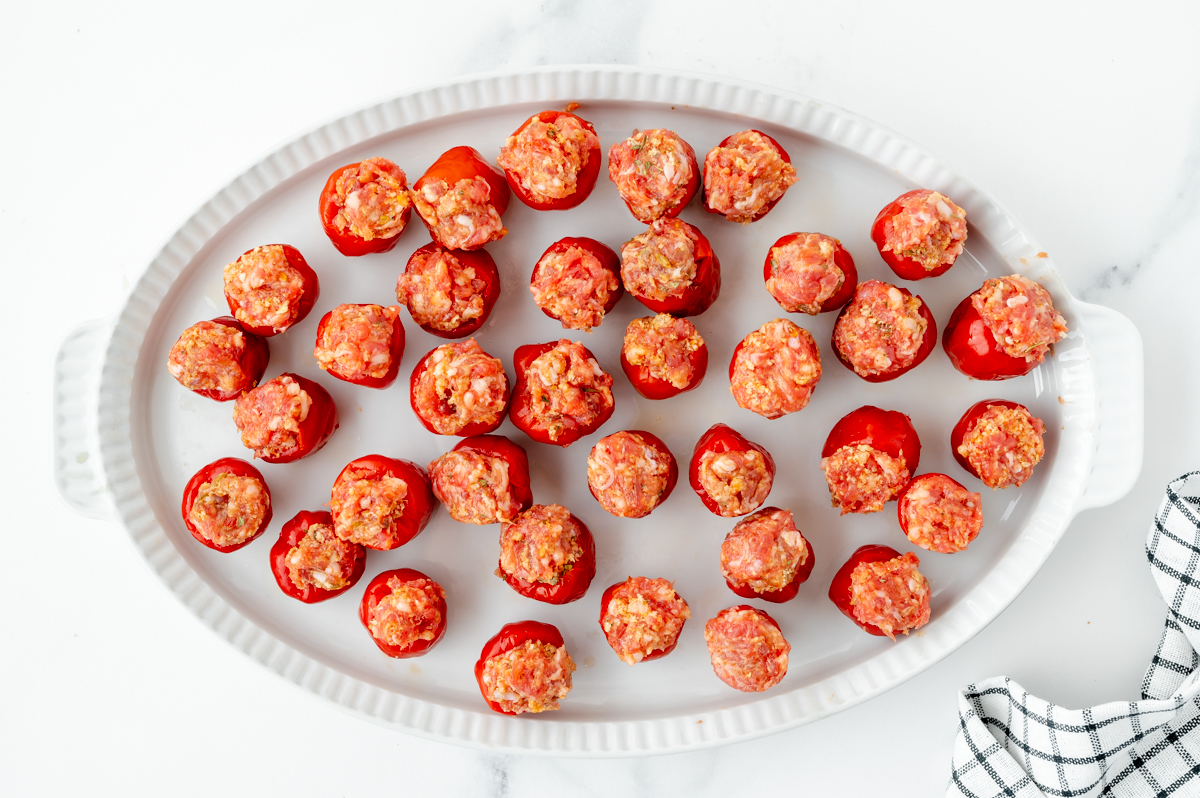 overhead shot of peppers stuffed with sausage on platter