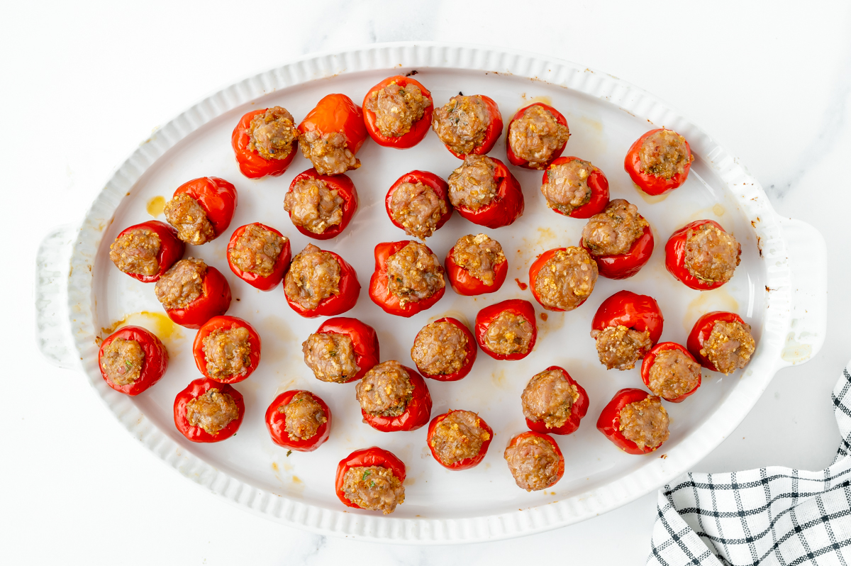 overhead shot of baked stuffed cherry peppers on platter