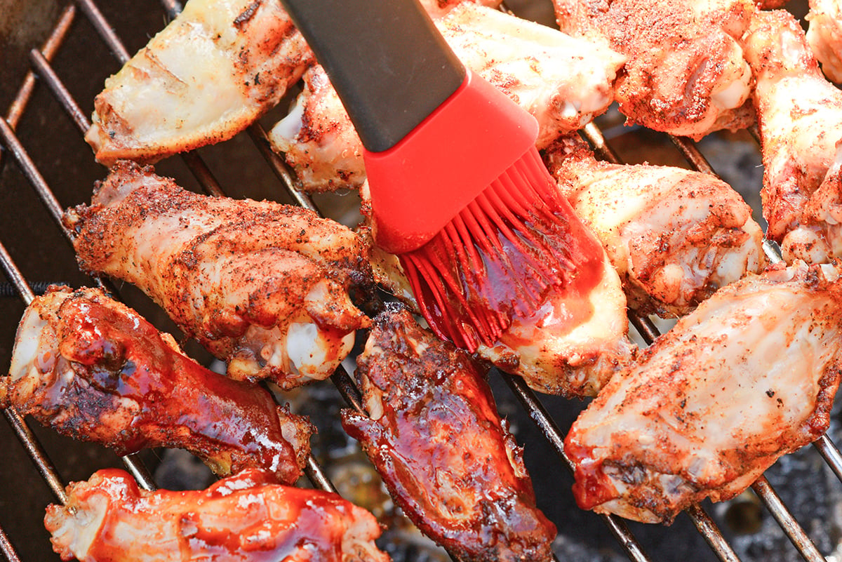 silicone brush basting BBQ sauce on copycat hickory smoke BBQ wingstop