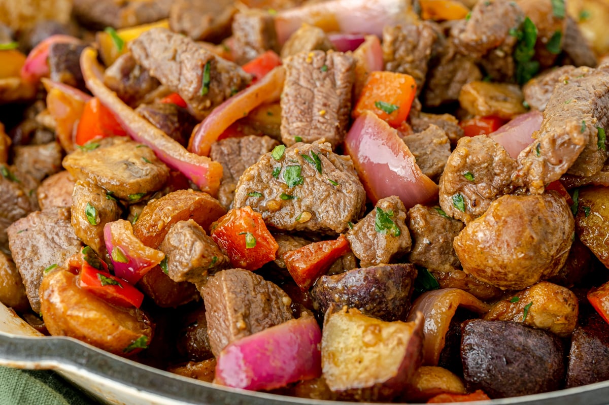 close up angled shot of steak and potato skillet