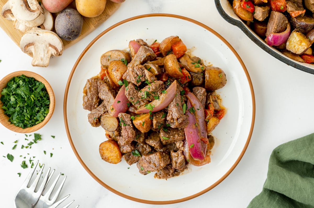 overhead shot of plate of steak and potato skillet