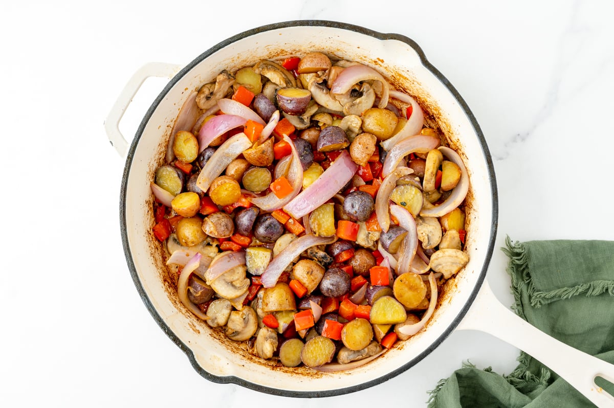potatoes, onions and mushrooms cooking in pan
