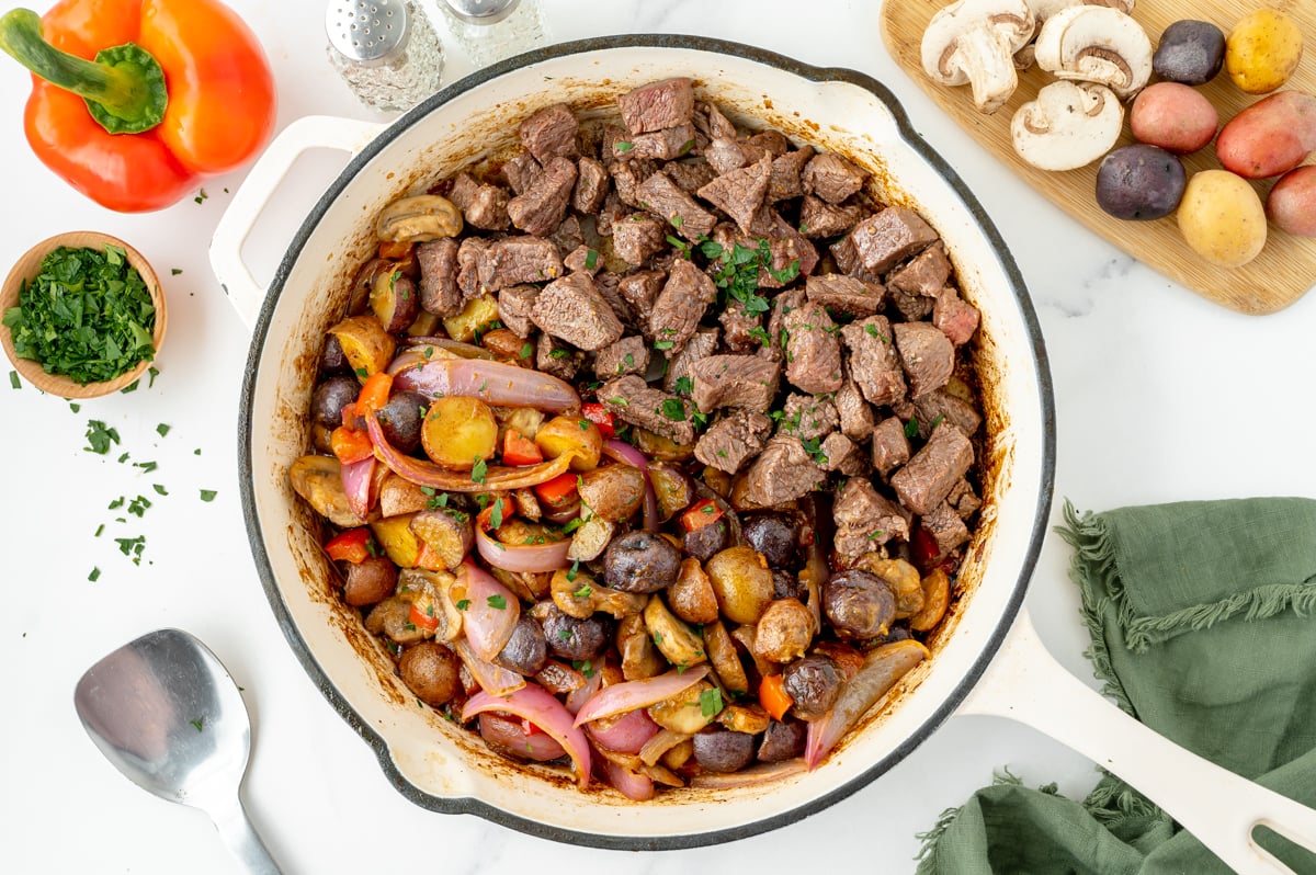 overhead shot of steak, potatoes and veggies in pan