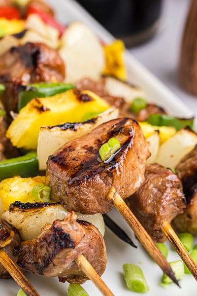 close up of teriyaki pork skewers