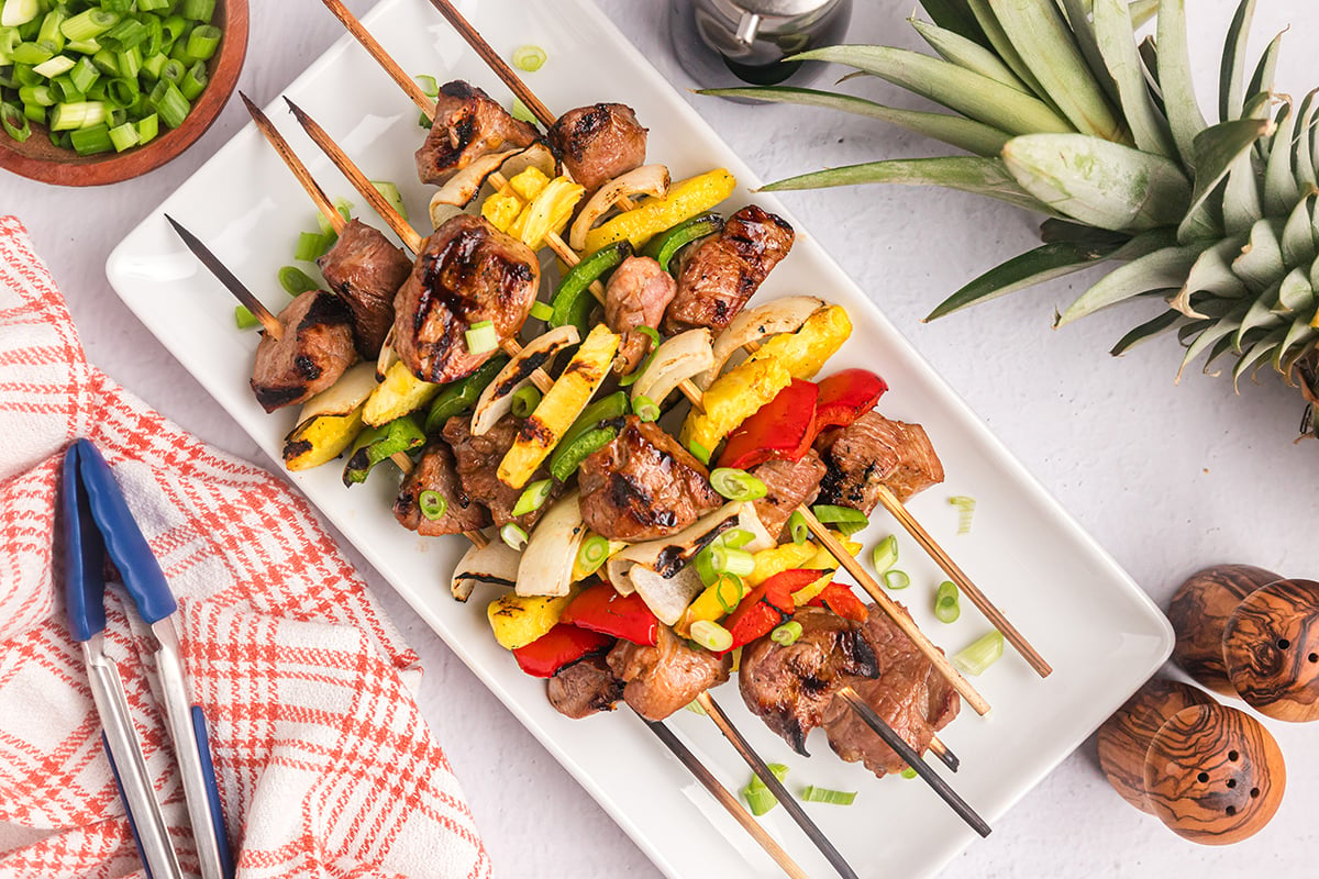 overhead shot of teriyaki pork skewers on tray