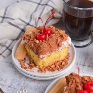 angled shot of slice of tiramisu poke cake on plate