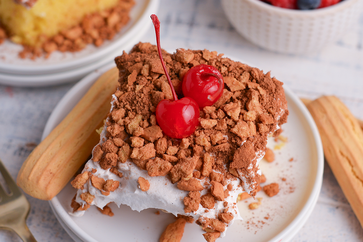 close up angled shot of tiramisu poke cake slice on plate