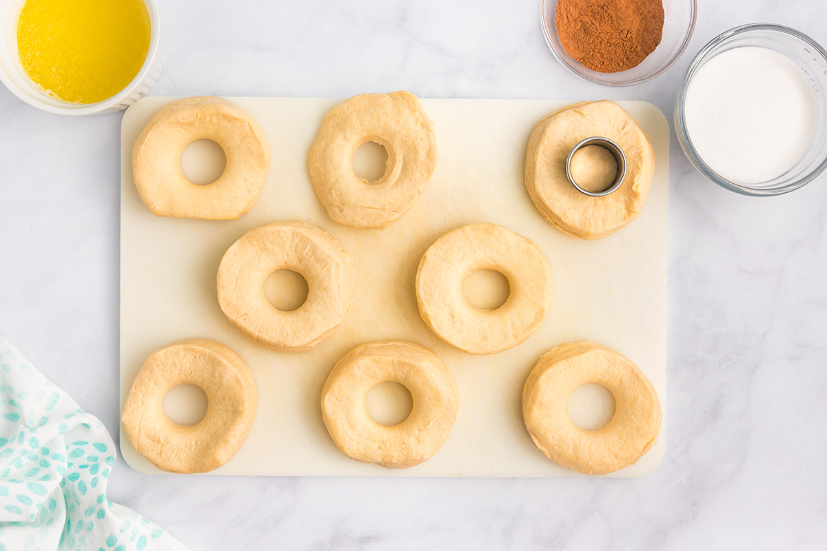 cutting holes in biscuit dough on a cutting board