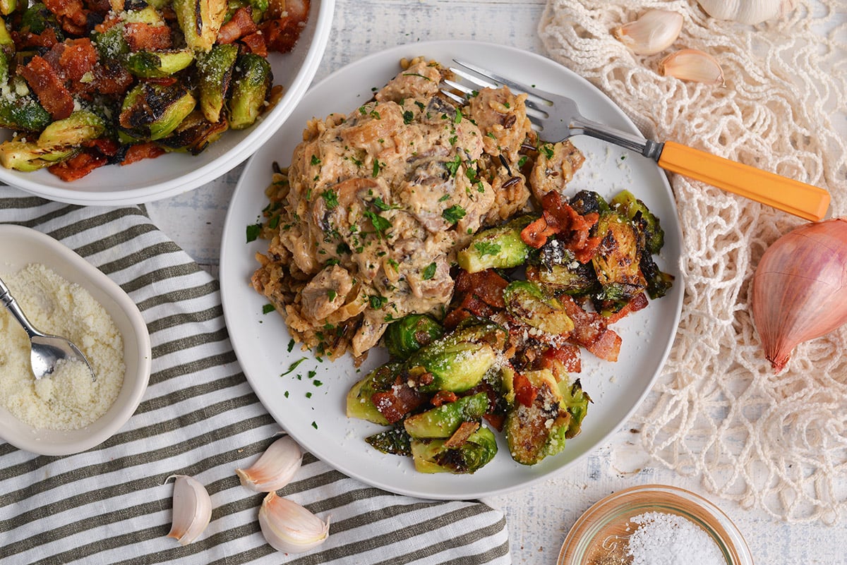 overhead shot of plate of stroganoff and brussels sprouts with bacon