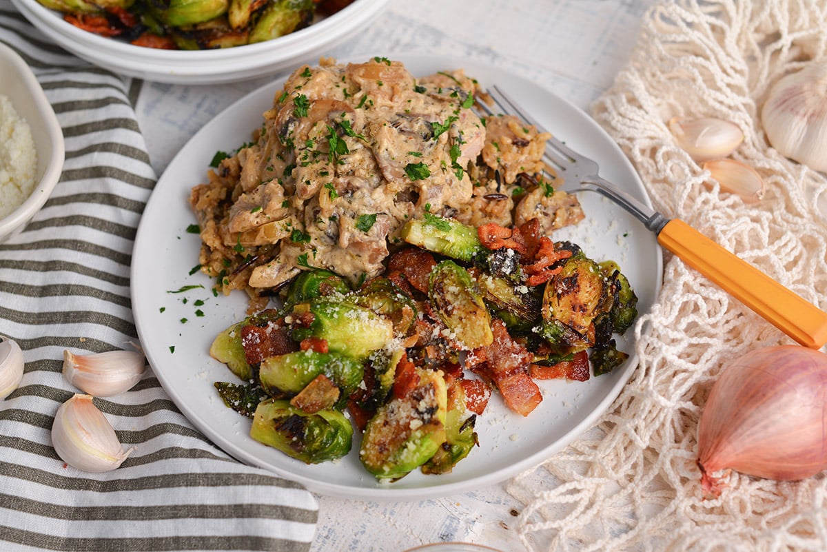 angled shot of plate of stroganoff and brussels sprouts with bacon