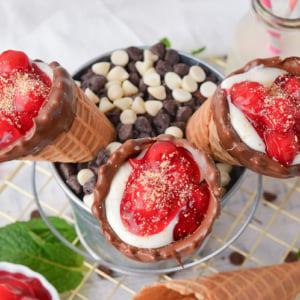 overhead shot of three cherry cheesecake cones