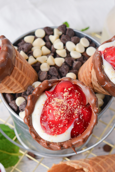 overhead shot of three cherry cheesecake cones