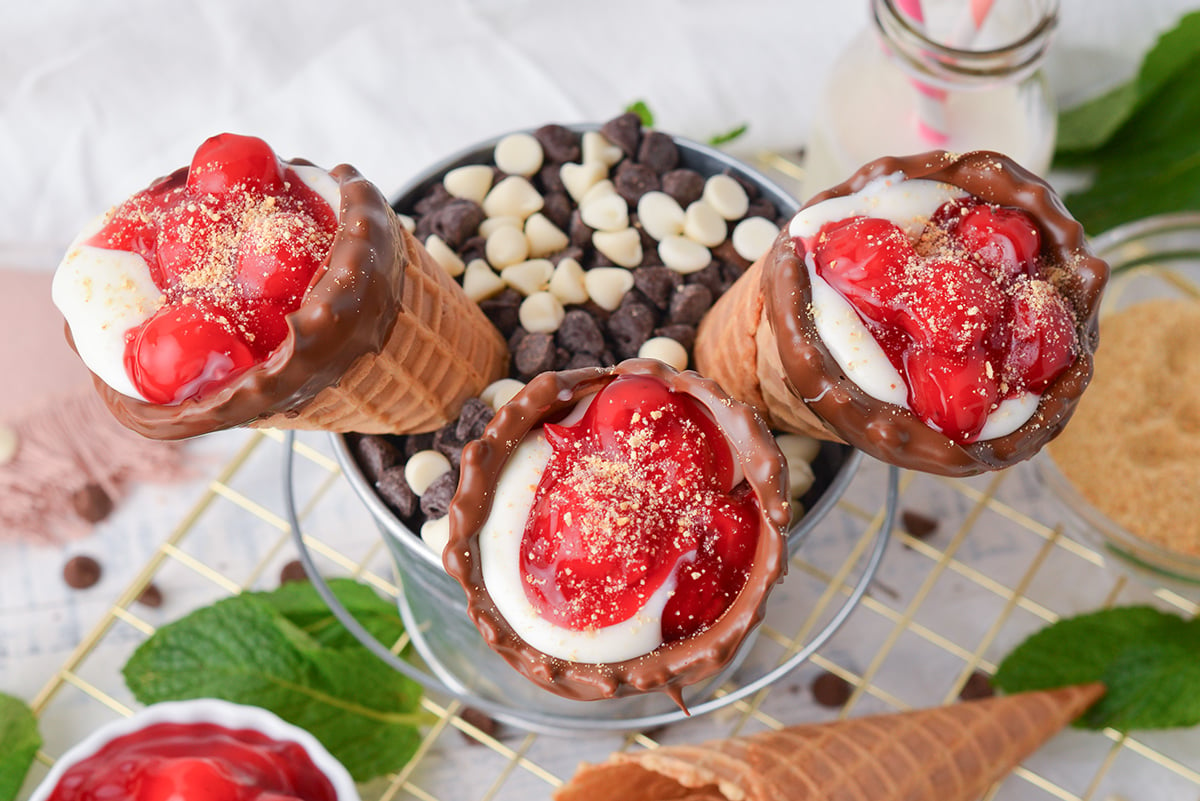 overhead shot of three cherry cheesecake cones