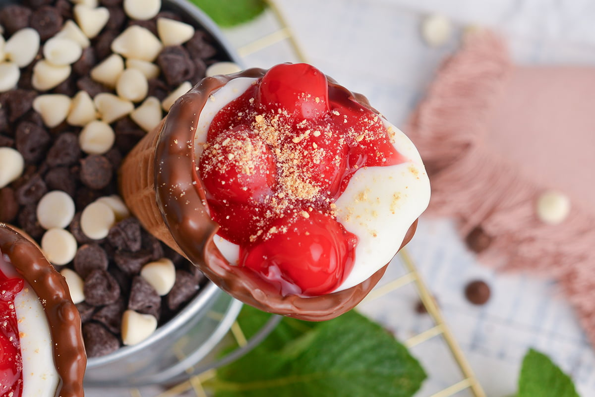 close up overhead shot of cherry cheesecake cone