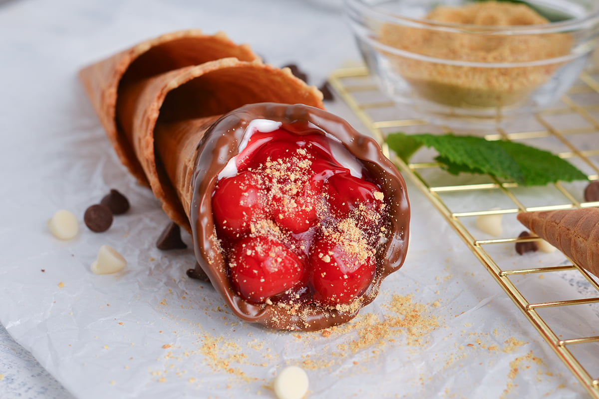 angled shot of cherry cheesecake cone laying on parchment paper