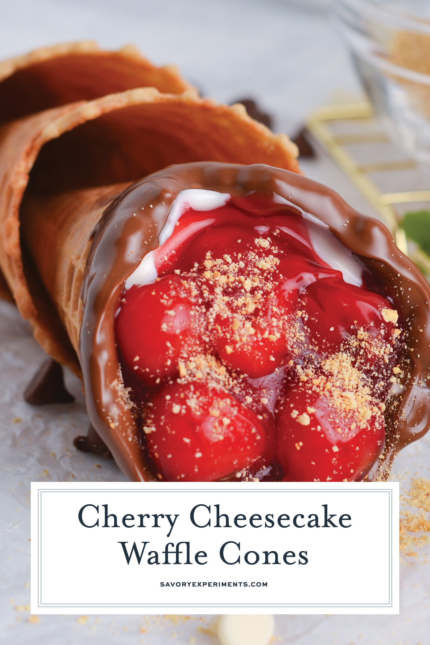 angled shot of cherry cheesecake cone laying on parchment paper with text overlay