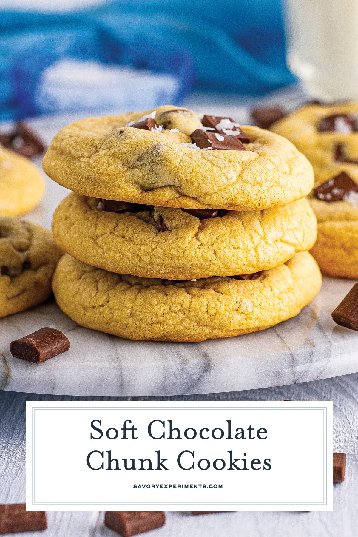 close up stack of chocolate chunk cookies on a marble board with text overlay