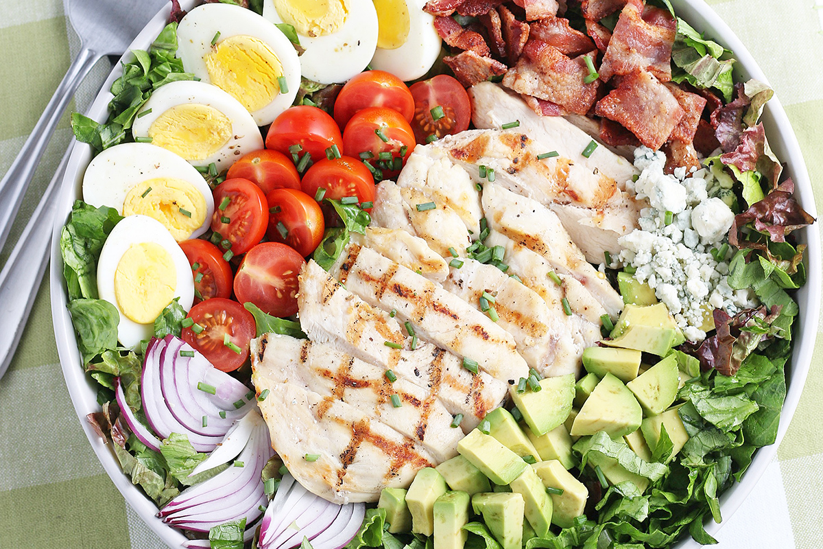 close up of sliced chicken on cobb salad