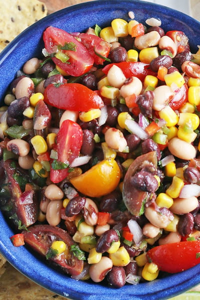 overhead of cowboy caviar with tortilla chips and lime