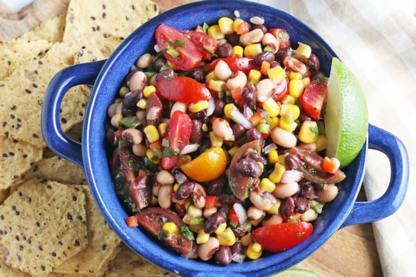 overhead of cowboy caviar with tortilla chips and lime