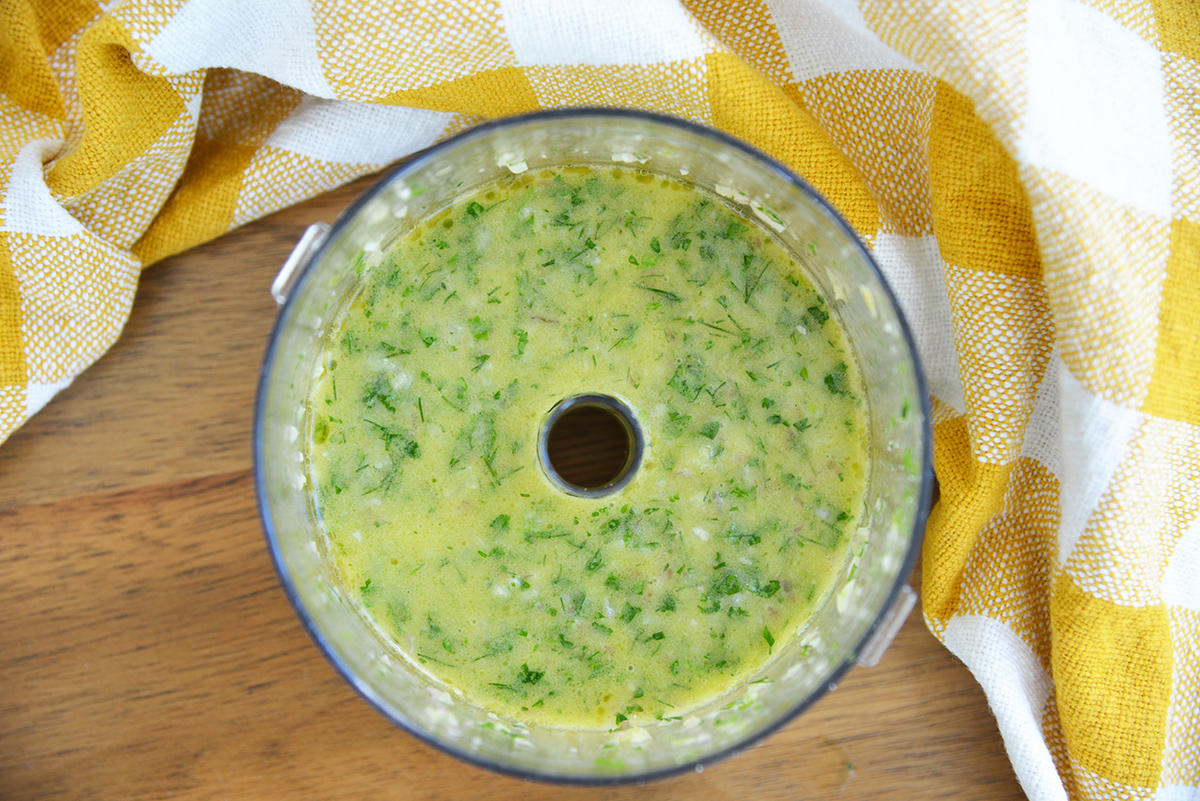 fresh herb dressing in the bowl of a food processor