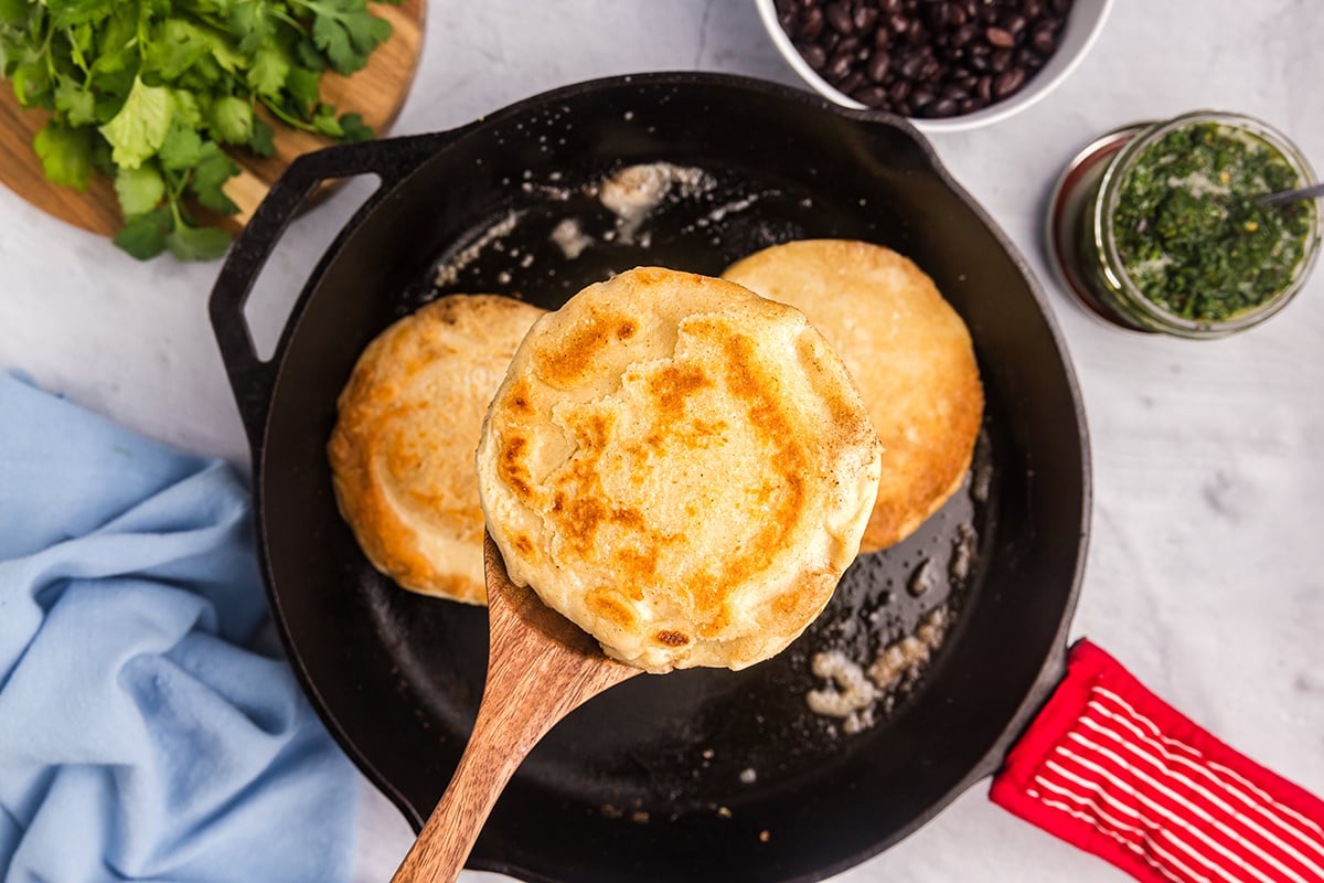 overhead shot of recipe for arepas on wooden spoon