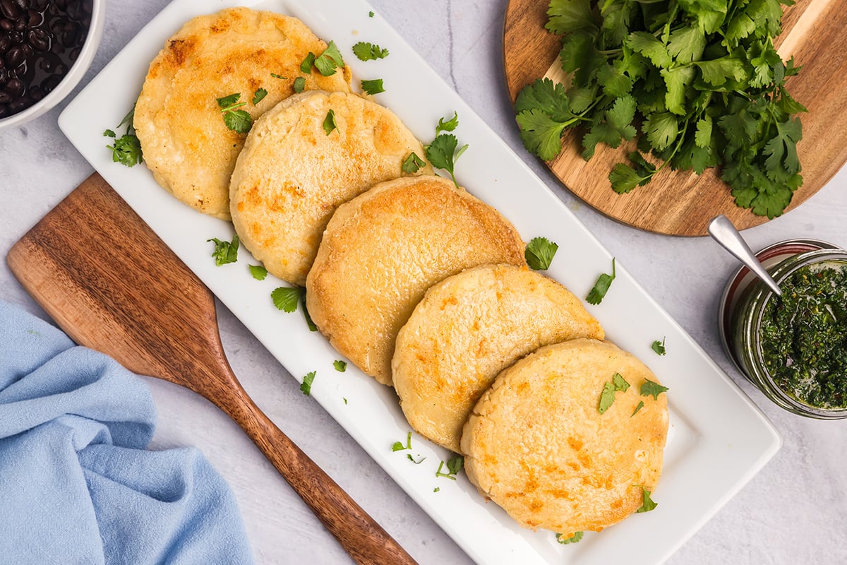 overhead shot of platter of easy arepas con queso