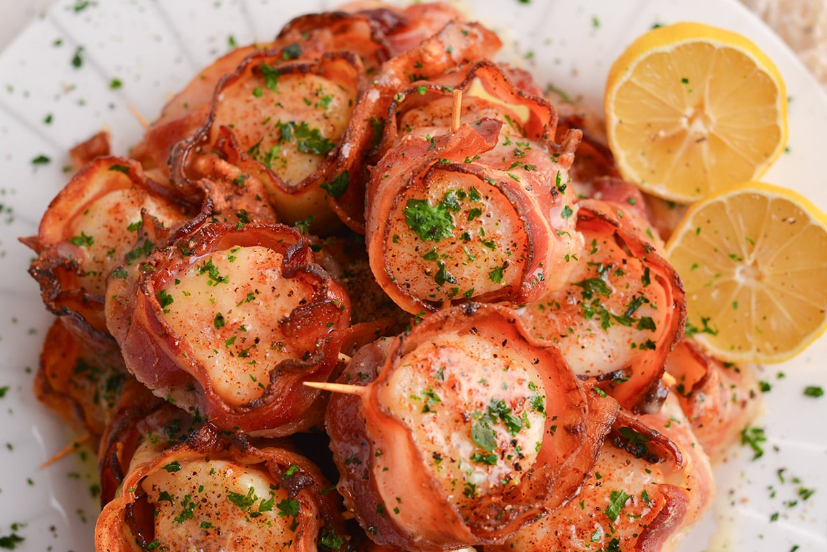 close up overhead shot of plate of bacon wrapped scallops in oven