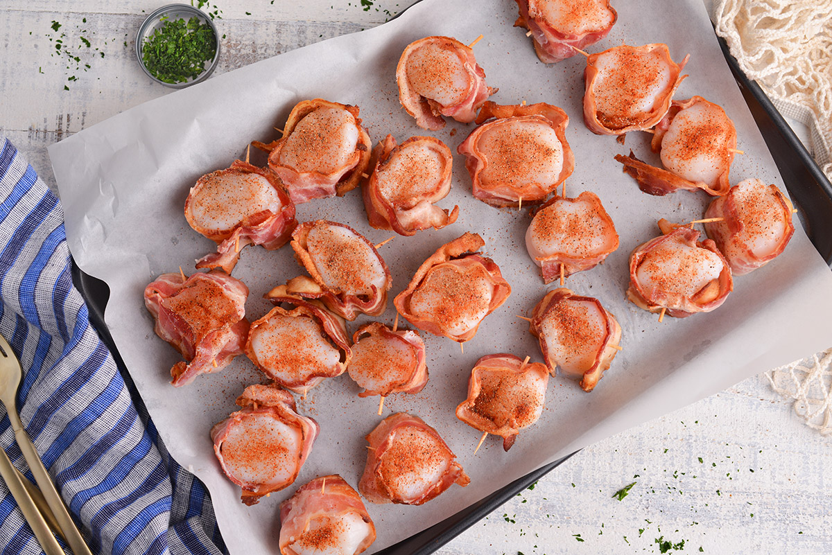 overhead shot of baking sheet of bacon wrapped scallops