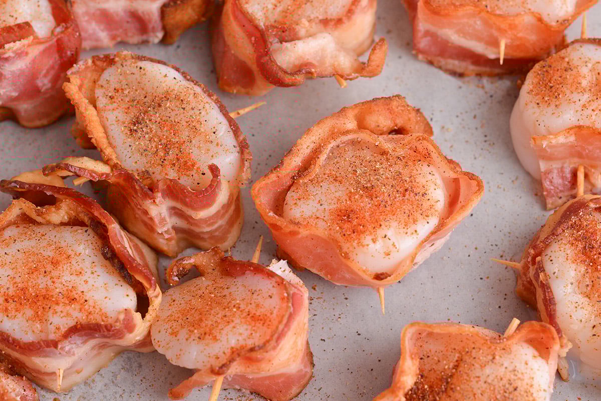 close up shot of scallops wrapped in bacon
