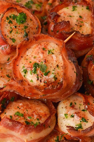 close up overhead shot of plate of scallops wrapped in bacon