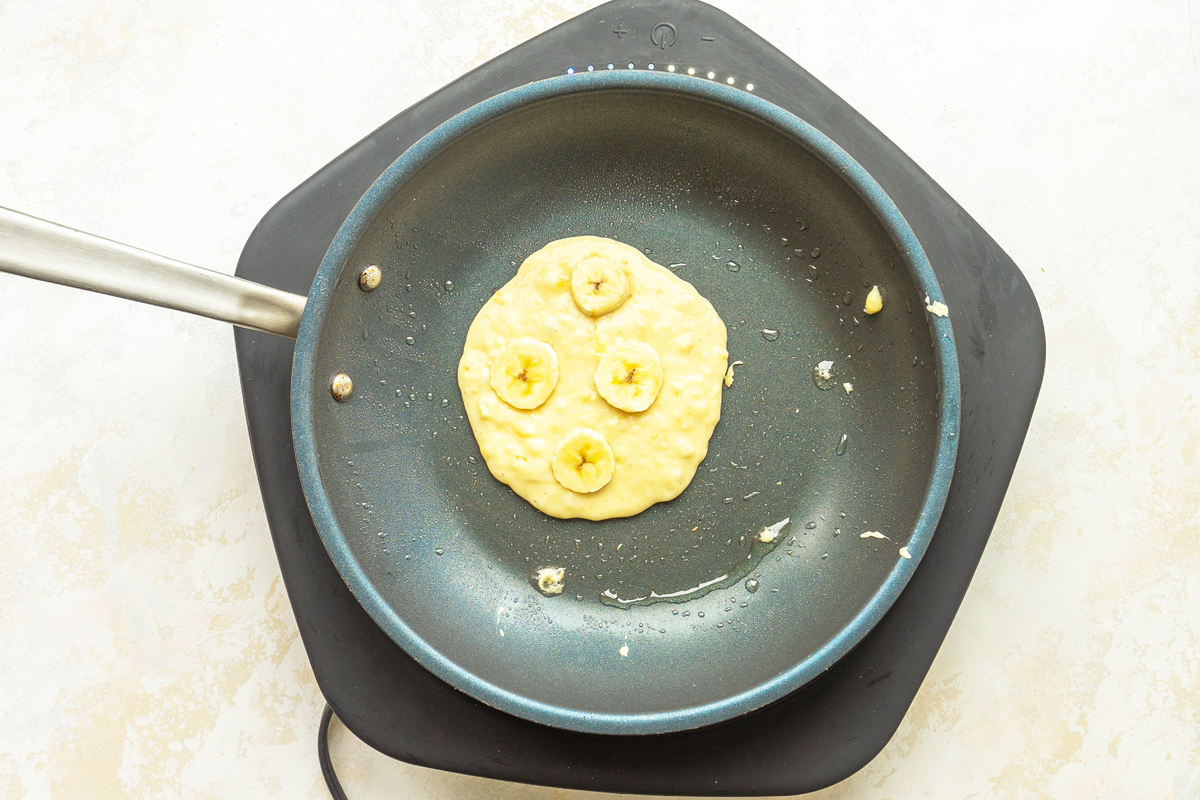 overhead shot of banana pancake batter in pan