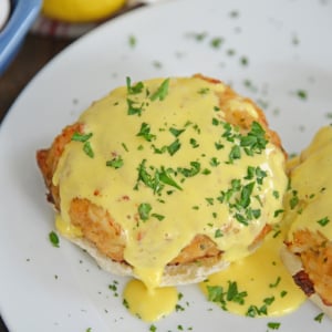close up angled shot of crab cakes hollandaise