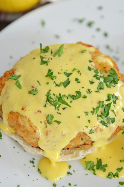 close up angled shot of crab cakes hollandaise