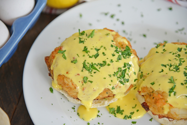 close up angled shot of crab cakes hollandaise