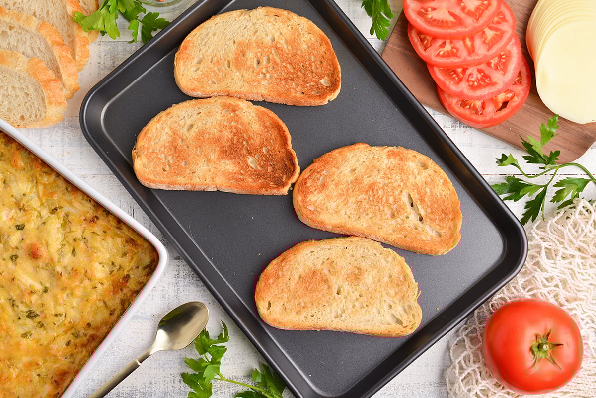 overhead shot of toasted bread on baking sheet