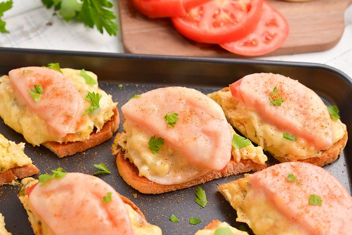 angled shot of open face crab sandwich on baking sheet
