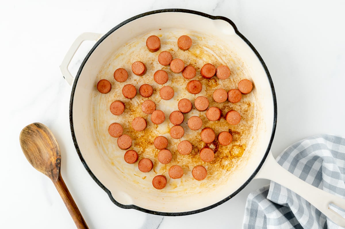 hot dogs cooking in pan