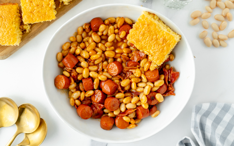 overhead shot of bowl of beanie weenies with cornbread