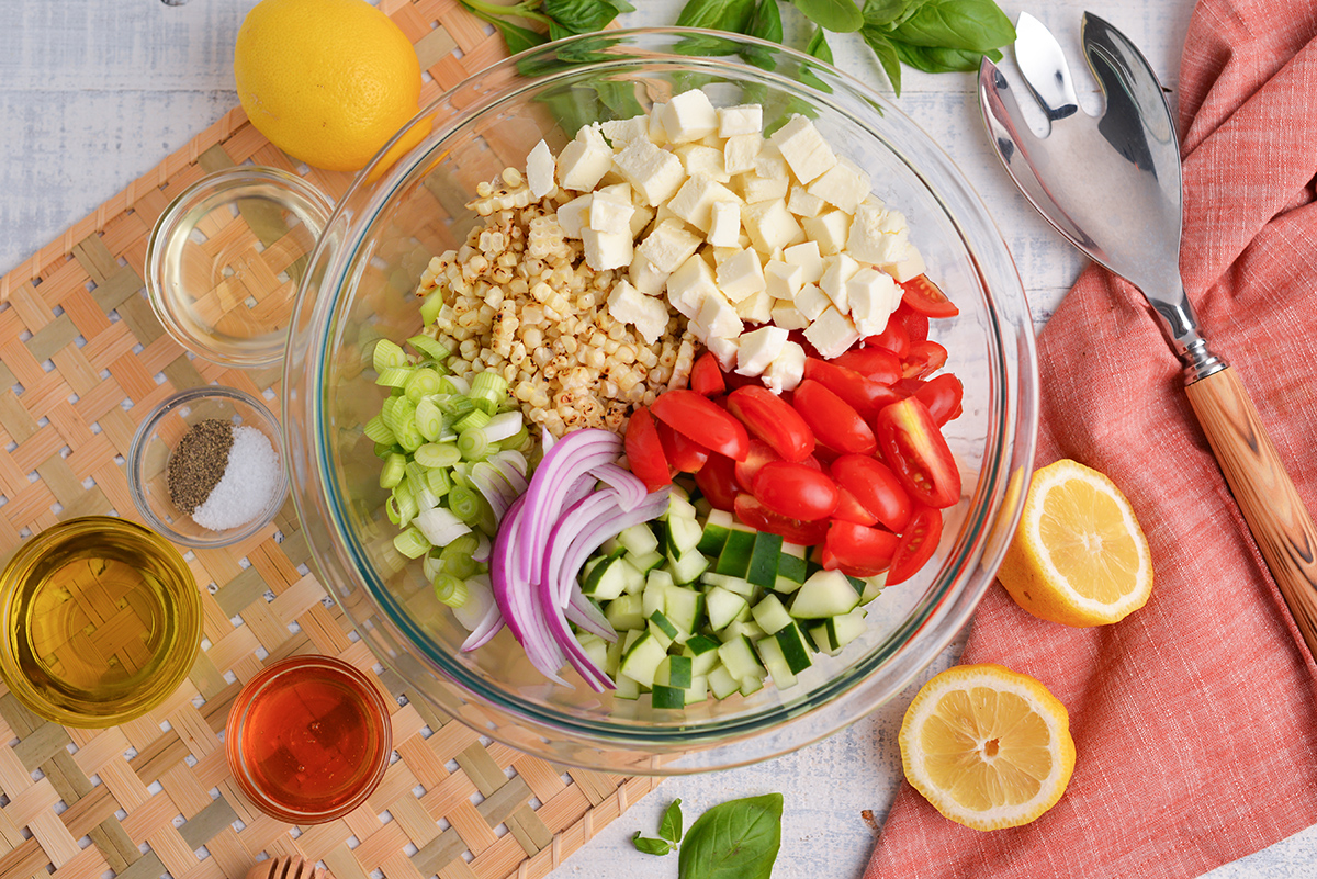 cheese, corn, scallions, tomatoes and onion in bowl