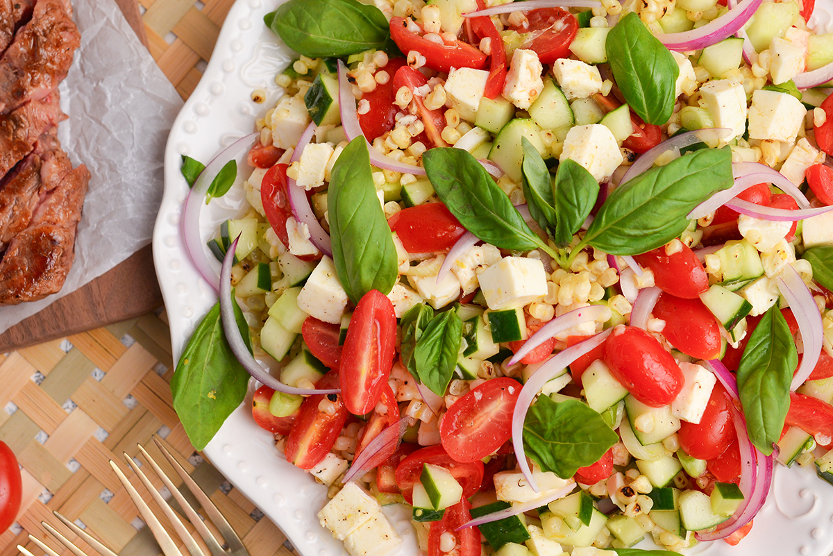 close up overhead shot of grilled corn salad on plate