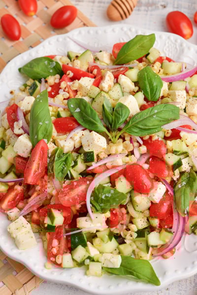 angled shot of grilled corn salad on plate