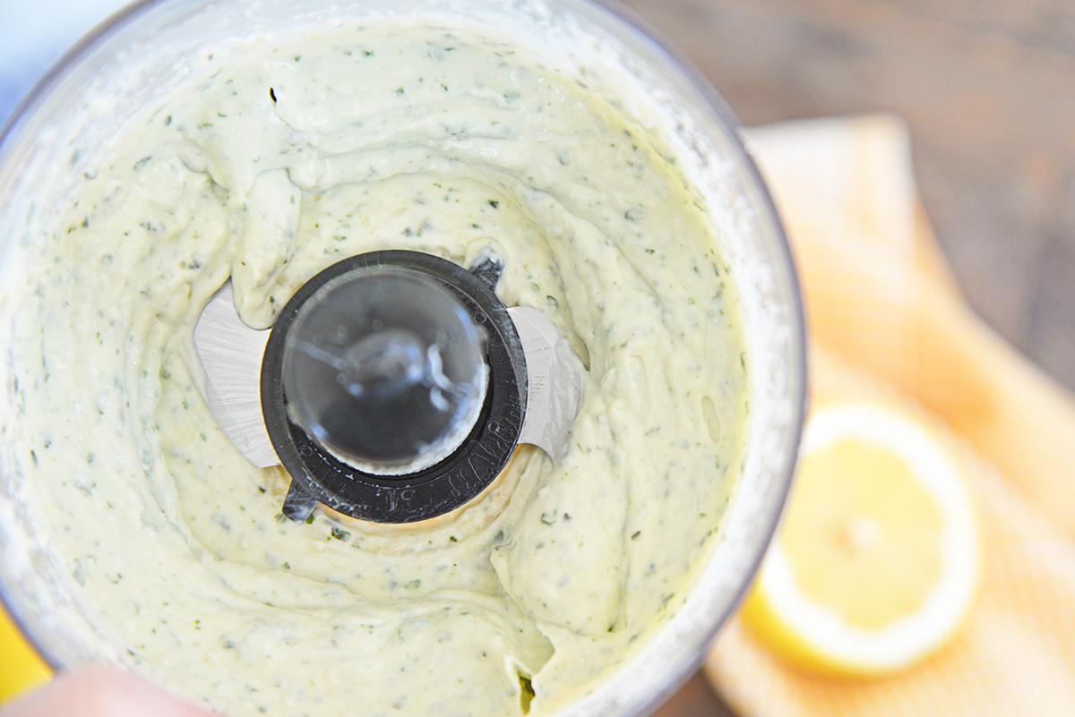 close up overhead shot of pesto aioli sauce in food processor