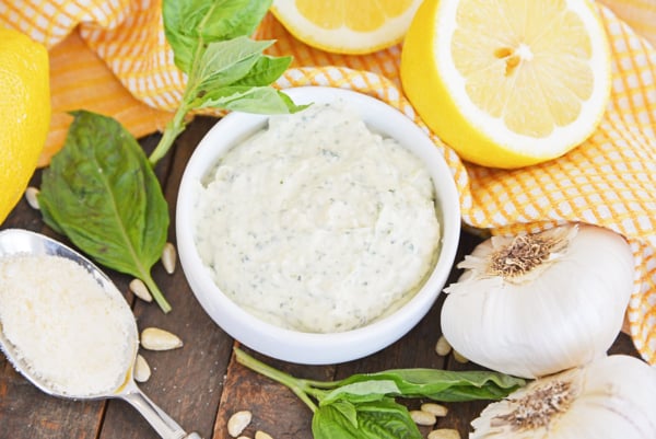 angled shot of pesto aioli sauce in white bowl