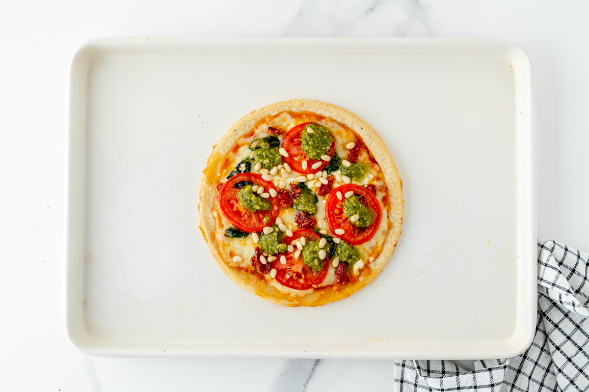 pine nuts added to tomato pesto pizza