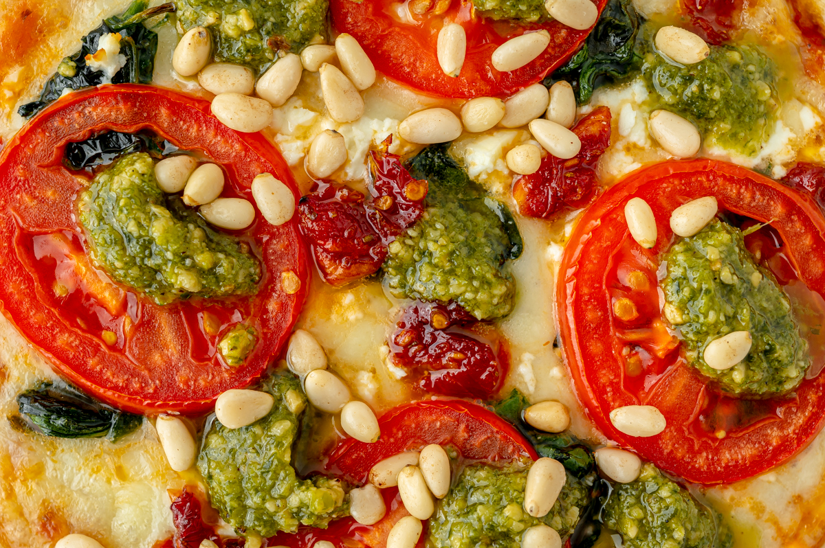 close up overhead shot of pesto on pizza