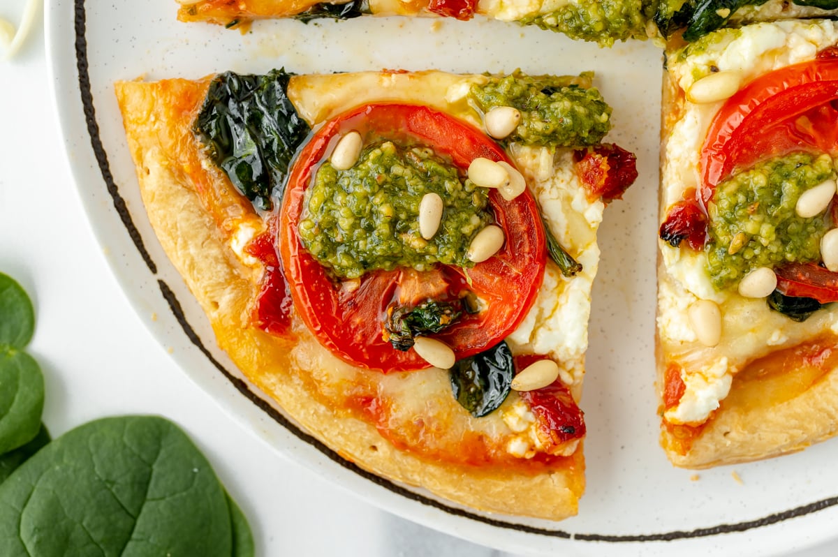 close up of slice of pizza on plate